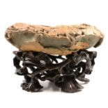 Large Chinese carved hardstone bowl, on carved and open wooden stand,