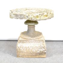 Stone garden pedestal with a mill stone top,