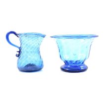 A blue glass cream jug and a sugar bowl