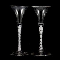 A near pair of Georgian style opaque twist wine glasses