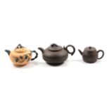 Three Chinese redware teapots, and two porcelain teapots