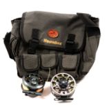 Collection of modern fly fishing reels, fly tying kit and feathers.