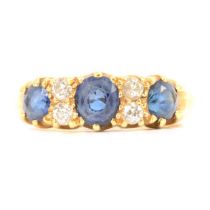 A sapphire and diamond half hoop ring.