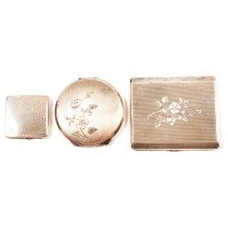 Two silver powder compacts and a cigarette case.