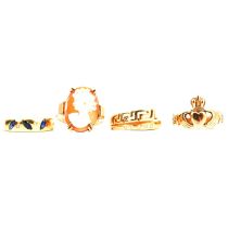 A cameo ring, Claddagh ring and two gemset rings.