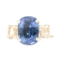 A sapphire and diamond three stone ring.