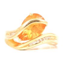 A citrine and diamond crossover ring.