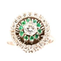 An emerald and diamond reverse cluster ring.