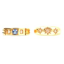 A diamond three stone gypsy set ring and a sapphire and diamond ring.