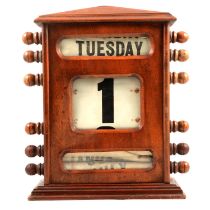Walnut cased desk top perpetual calendar,
