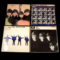 Four The Beatles LP vinyl records and a box of 12" singles