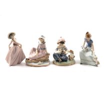 Seven Lladro and Nao figurines.