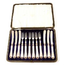 Set of six silver handled dessert knives and forks, etc.,