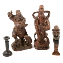 Two carved Chinese figures, nutcracker, and ebony candlesticks