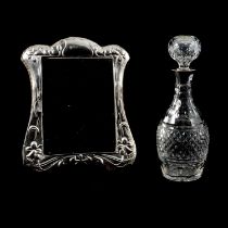 Silver-framed mirror, Keyford Frames Ltd, London 1983, and silver-mounted glass decanter.