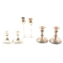 Two pairs of silver candletsicks, and a pair of bud vases (weighted)