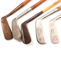 A collection of hickory shafted golf clubs.