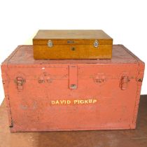 A wooden storage case and red trunk