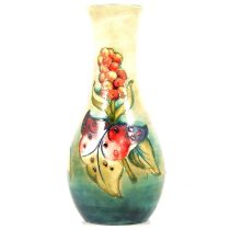 A Moorcroft tall baluster vase in the Aurum Lily design.