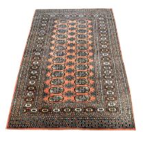 Bokhara rug, two rows of thirteen guls on a salmon coloured field, multi-bordered, 160x97cm.