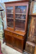 A late Victorian mahogany bookcase cupboard, width 108cm, depth 52cm, height 215cm