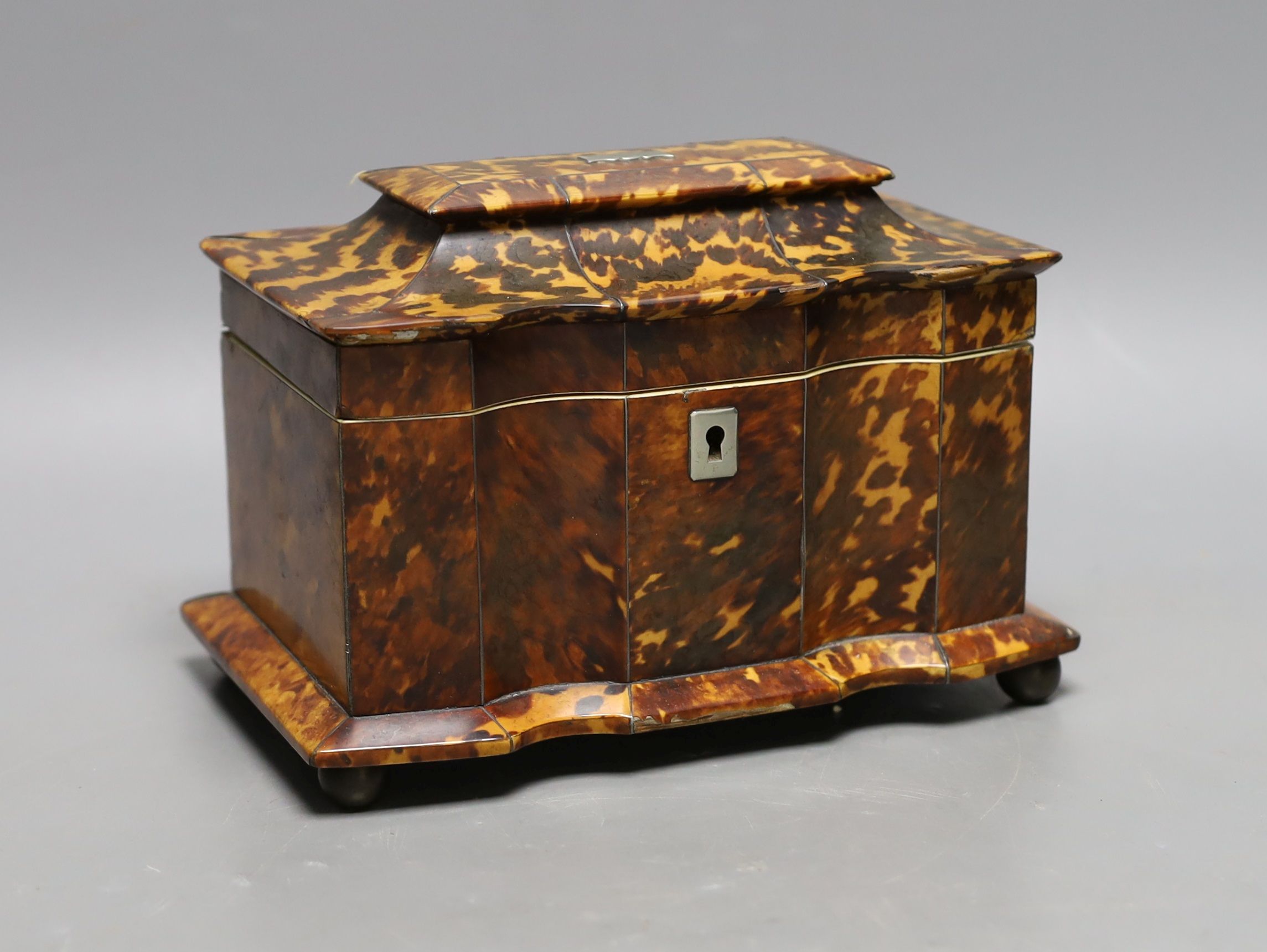 A 19th century tortoiseshell veneered tea caddy, ivory veneered edging, 20cms wide Ivory