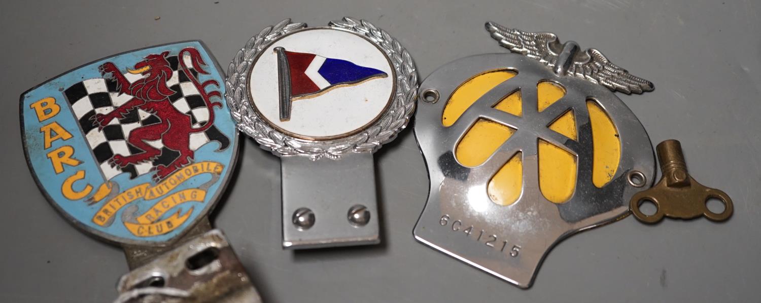 A British Automobile Racing Club car badge, an AA badge and one other