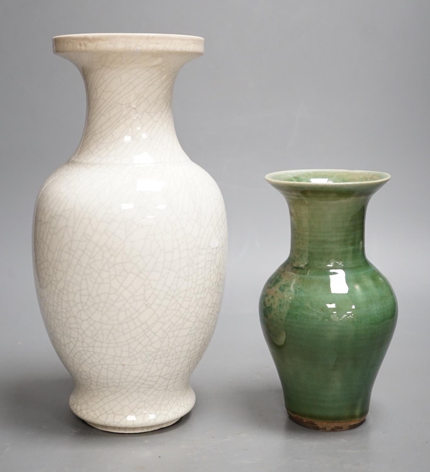 A Chinese white crackleware vase and a smaller green glazed vase,