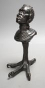 A bronze slave portrait bust on claw stand. 23cm high