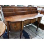 A George IV mahogany serpentine sideboard, width 214cms, depth 86cms, height 132cms.