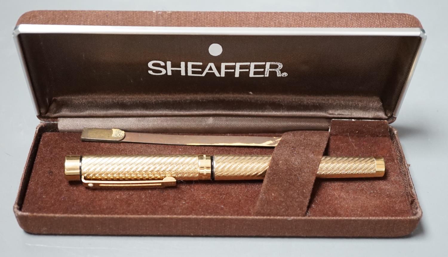 A cased gold plated Shaeffer fountain pen