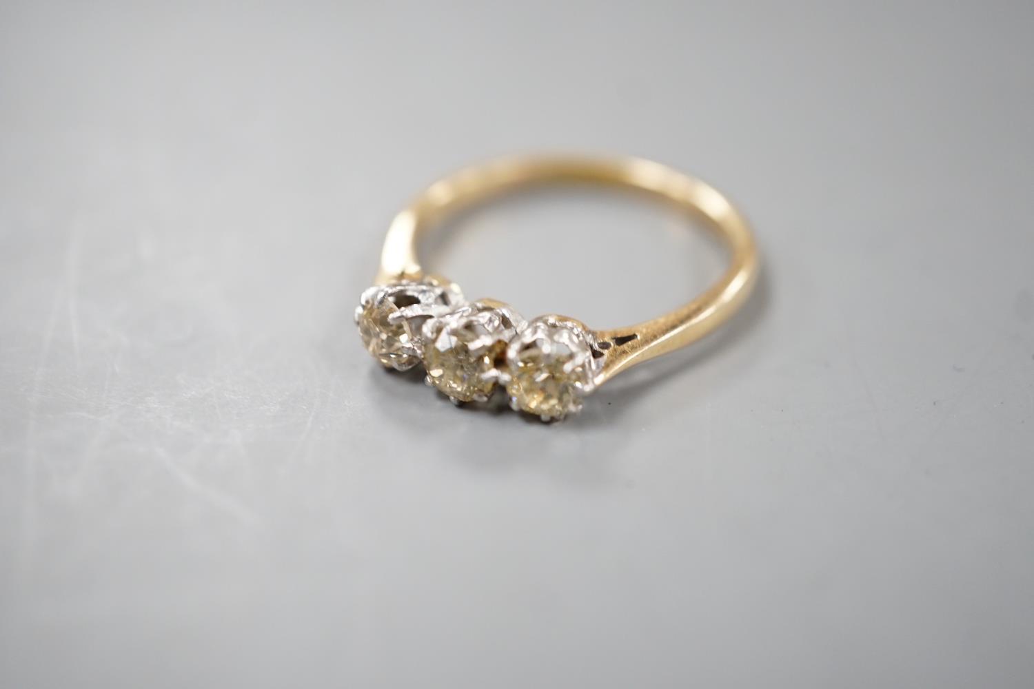 An 18ct and three stone diamond set ring, size P, gross weight 2.8 grams. - Image 5 of 5