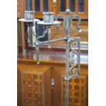 A pair of Arts & Crafts adjustable wrought iron candle lamp standards, height 157cm Height 158 cm