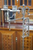 A pair of Arts & Crafts adjustable wrought iron candle lamp standards, height 157cm Height 158 cm