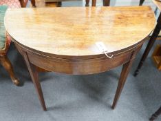 A George III mahogany and boxwood strung D shaped folding card table, width 91cm, depth 45cm, height