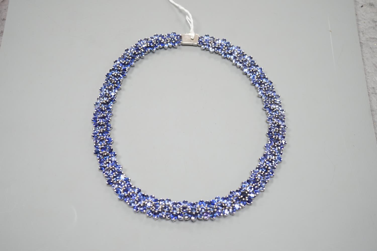 A continental base metal and synthetic sapphire? flower head cluster set necklace, approximately - Image 2 of 4