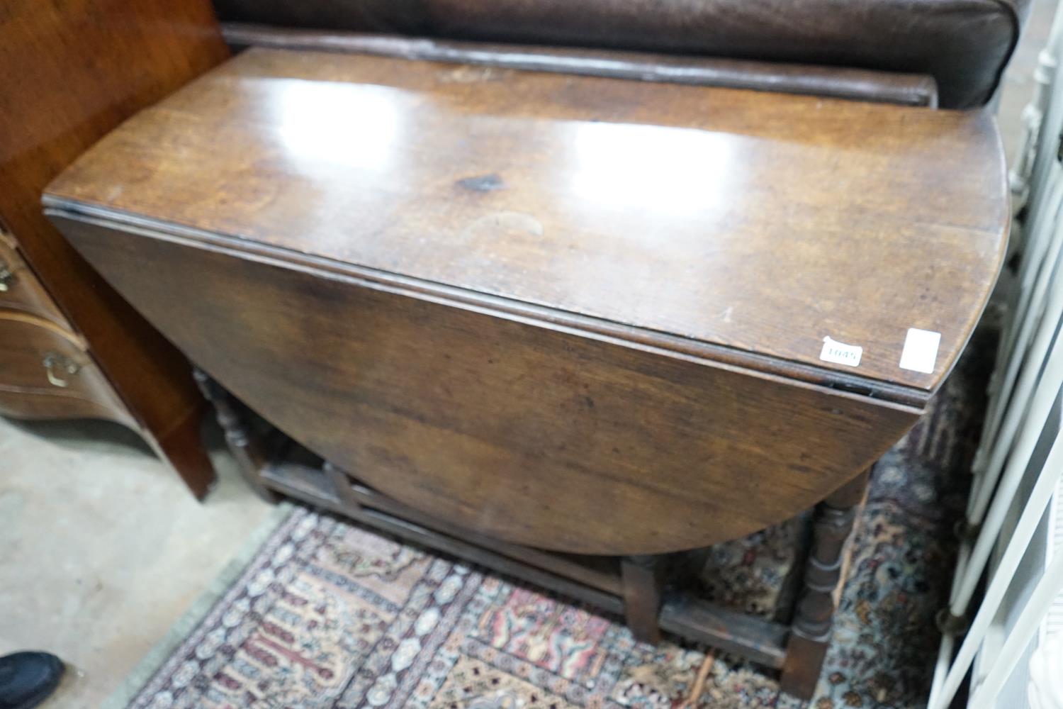 An 18th century oak gateleg dining table, length 141cm extended, width 120cm, height 74cm