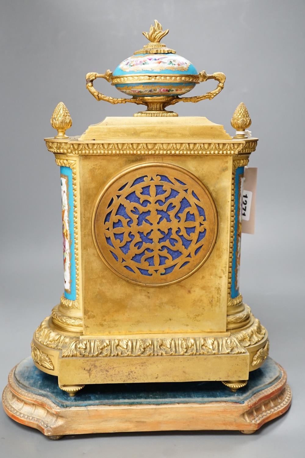A French ormolu mantel clock, with inset floral decorated porcelain plaques and dial, 40cms high - Image 5 of 7