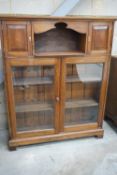 A Victorian style glazed walnut bookcase width 110cms, depth 26cms, height 136cms.