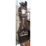 An early 20th century Flemish carved oak and walnut longcase clock, height 240cms.