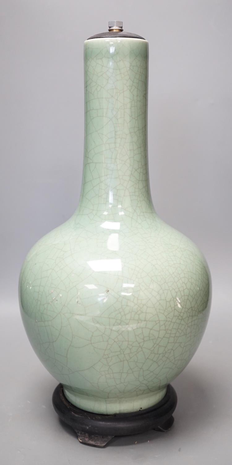 A Chinese celadon glazed Guan type vase on stand, 42 cms high