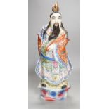 A Chinese enamelled porcelain figure of an immortal, early 20th century, 43cm