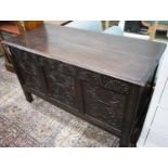 An 18th century carved, panelled oak coffer, width 130cm, depth 57cm, height 78cm