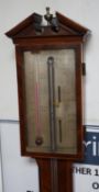 Cattely & Co, Holborn, London. A George III feathered walnut stick barometer, height 98cms. with