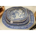 A 19th century transfer-printed large blue and white platter and seven similar smaller platters (8),