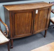 A George III mahogany and banded bowfront side cabinet with panelled doors on square tapering