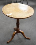 A George III circular oak tripod tilt top tea table on turned column, diameter 58cm, height 67cm