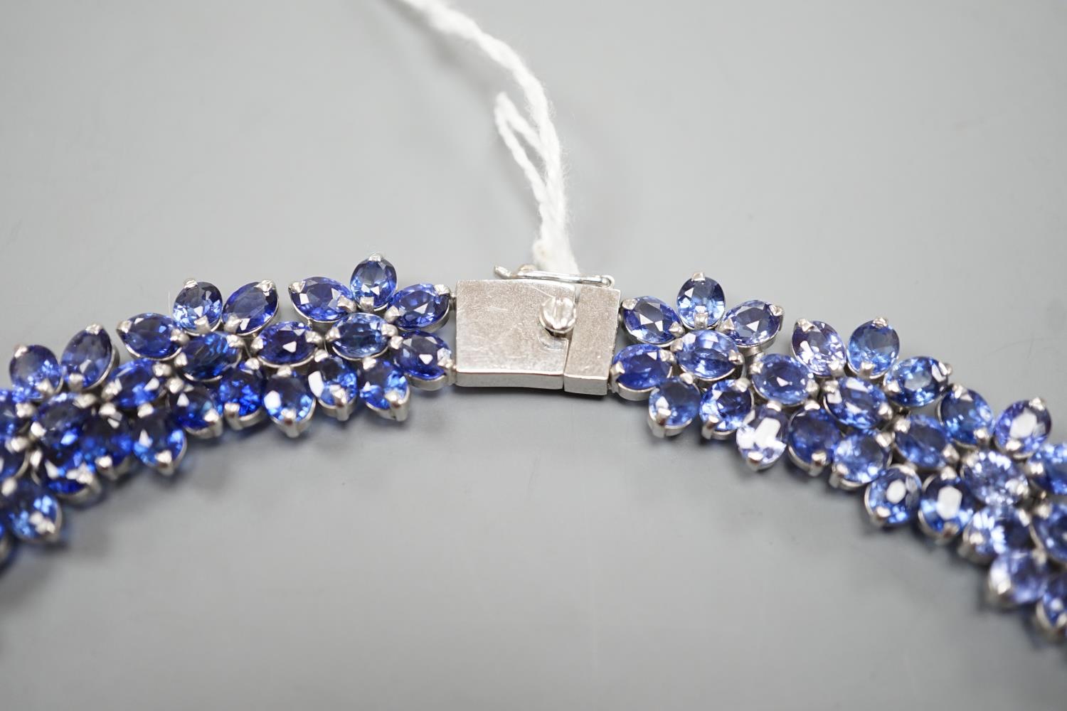 A continental base metal and synthetic sapphire? flower head cluster set necklace, approximately - Image 3 of 4