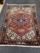 An Heriz red ground rug 200cms x 148cms