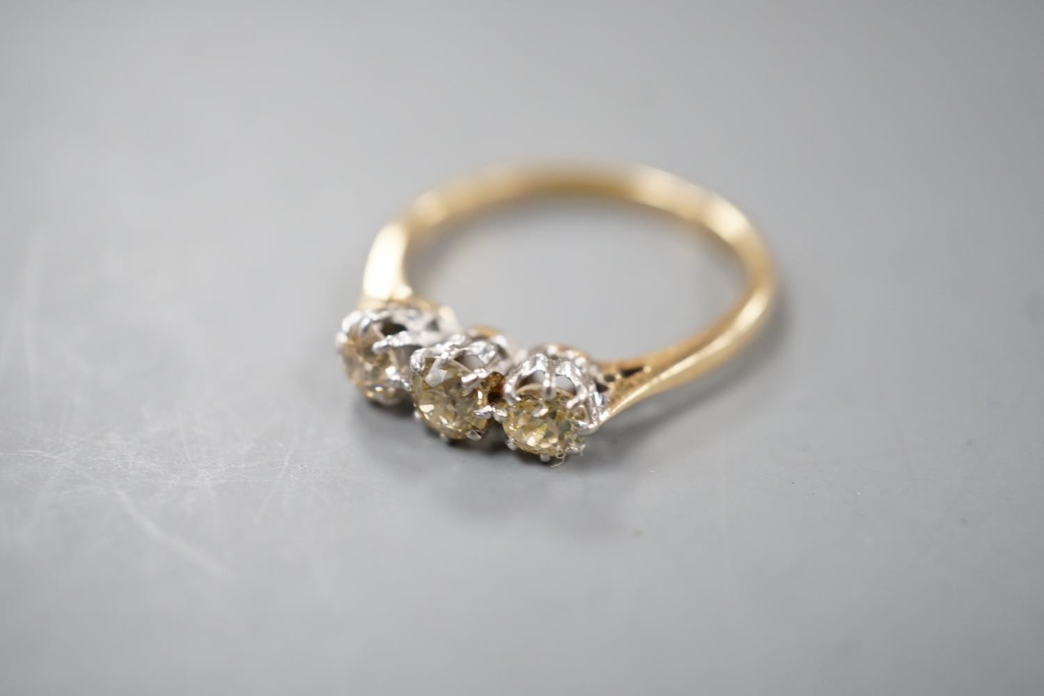 An 18ct and three stone diamond set ring, size P, gross weight 2.8 grams. - Image 4 of 5